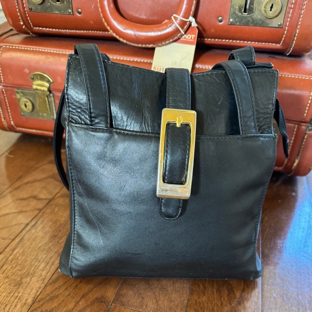 Laura Scott Black shoulder bag with front and back outer pockets, snap closure.